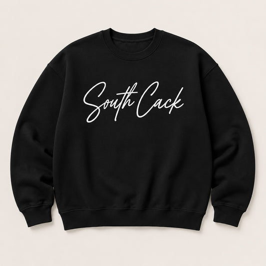 saysomethingteez black crewneck sweatshirt with white South Cack script graphic, featuring ribbed cuffs and hem.