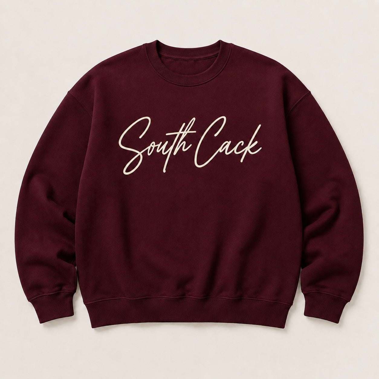 saysomethingteez maroon crewneck sweatshirt with white script South Cack graphic, featuring ribbed cuffs and hem.